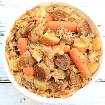 Crockpot Sausage and Sauerkraut ~ A hearty one-pot dinner with potatoes, carrots, garlic, onions, sauerkraut, and plant-based bratwurst.