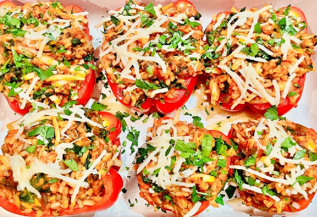 Italian Stuffed Peppers ~ Colorful bell peppers stuffed with a saucy mixture of rice, spinach, mushrooms, and vegan mozzarella for a delicious twist on the classic! These peppers are easy to make and ready to serve in about an hour.