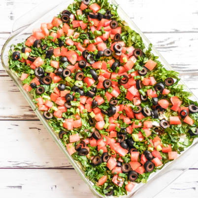 Vegan 7-Layer Party Dip ~ Layers of beans, fresh guacamole, for an easy crowd-pleasing appetizer!