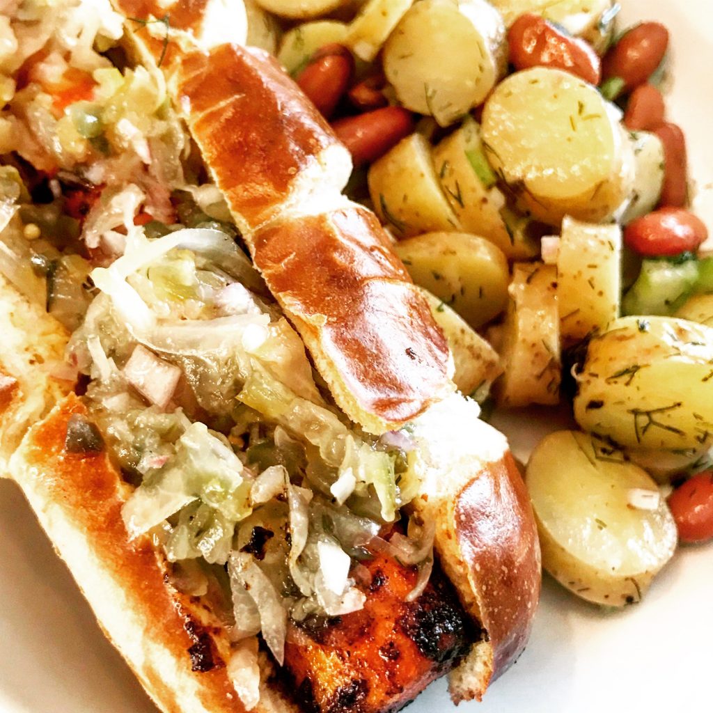 German Style Carrot Dogs | Pan-charred with smoky barbecue seasoning and served on toasted pretzel buns with spicy brown mustard and a mixture of sauerkraut and sweet relish, these carrot dogs are the perfect addition yo your vegan Oktoberfest menu!