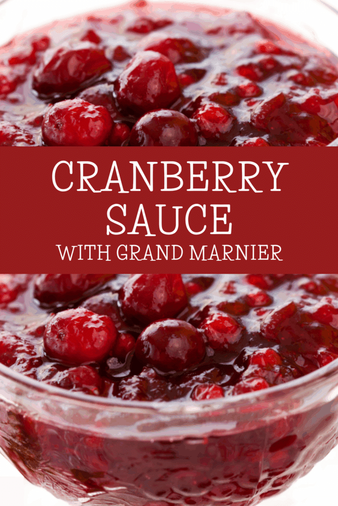 Close-up of a glass bowl filled with chunky grand marnier cranberry sauce, featuring whole cranberries and a glossy texture. Text overlay reads “Cranberry Sauce with Grand Marnier” in white on a red background.