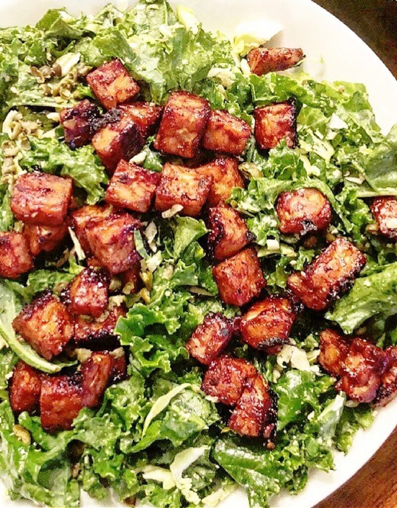 BBQ Tempeh Caesar Salad ~ Crispy tempeh served over garden fresh kale tossed in savory vegan Caesar dressing.
