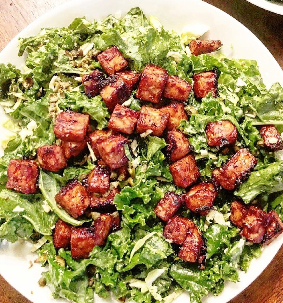 BBQ Tempeh Caesar Salad ~ Crispy tempeh served over garden fresh kale tossed in savory vegan Caesar dressing.
