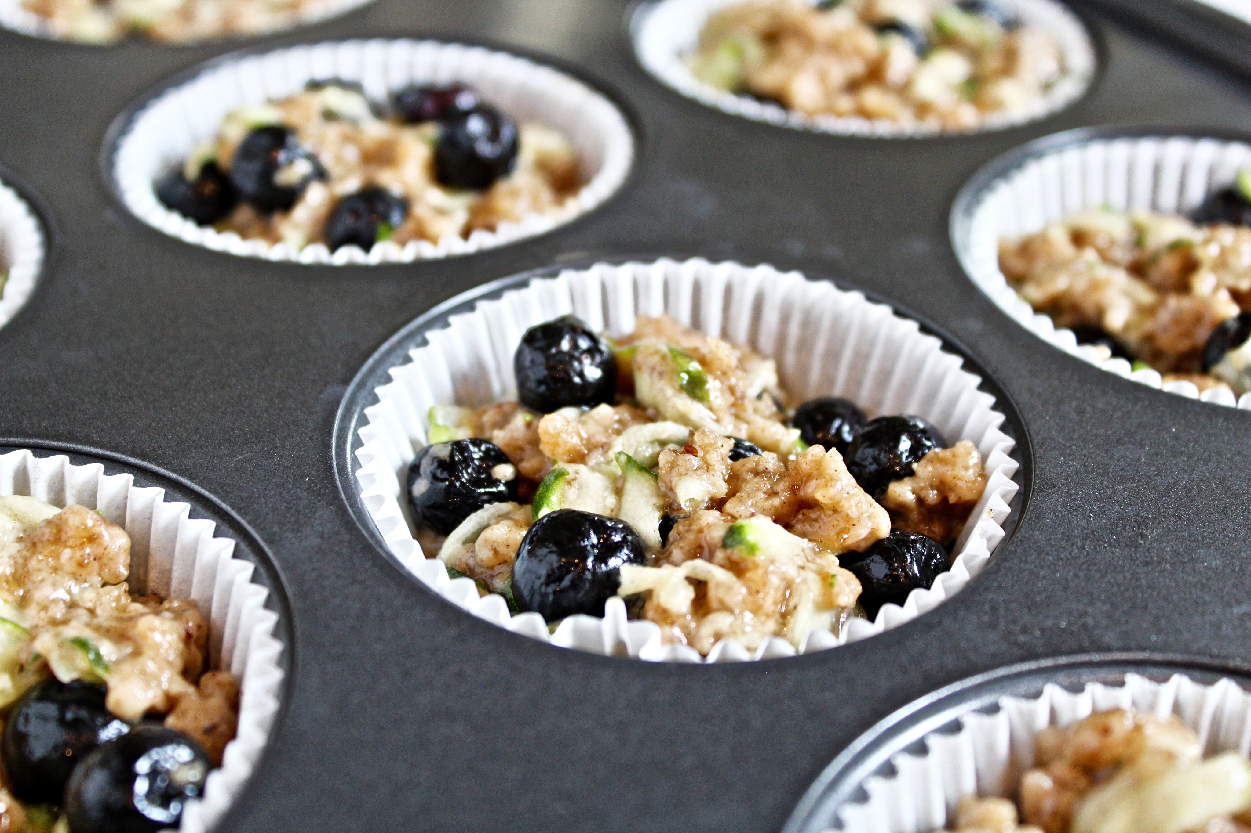 Blueberry and Zucchini Muffins with Streusel Topping - Sweet and savory flavors of the season shine in these quick easy vegan blueberry zucchini muffins that are perfect for breakfast or snacking! via @thiswifecooks