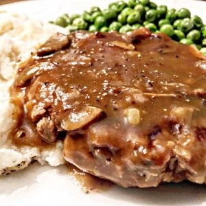 Vegan Salisbury Steak with Mushroom Gravy - Simple and satisfying, old school stick to your ribs comfort food. This one is sure to become a family favorite!