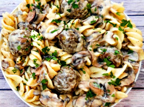 Vegan Lentil Meatball Stroganoff | A rich and creamy stroganoff made with homemade, pan-seared lentil meatballs tossed in a vegan sour-cream-and-mushroom sauce and served over wide fusilli pasta.
