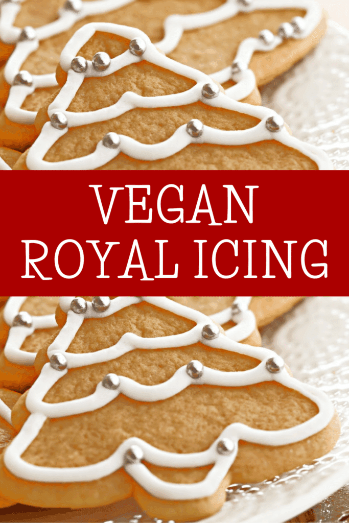 Christmas tree-shaped cookies decorated with vegan royal icing and silver sprinkles on a plate, with the text VEGAN ROYAL ICING in bold white letters on a red banner across the center.