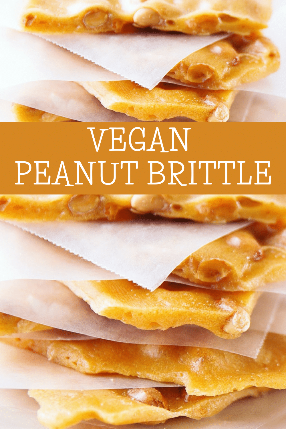 Close-up of stacked pieces of golden traditional vegan peanut brittle separated by parchment paper, with the words Vegan Peanut Brittle in white text over an orange banner across the center.