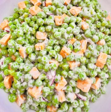 Green Pea and Cheddar Salad - A classic side dish made with only a handful of simple plant-based ingredients! #veganpotluck #veganeasterrecipes #plantbasedsidedish #thiswifecooksrecipes #easyveganrecipes #veganbrunchrecipes #veganpeasalad #veganbbqside