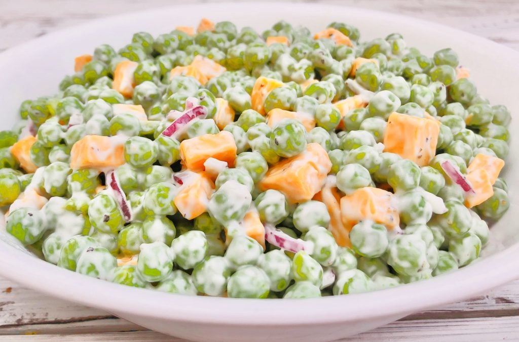 Green Pea and Cheddar Salad - A classic side dish made with only a handful of simple plant-based ingredients! #veganpotluck #veganeasterrecipes #plantbasedsidedish #thiswifecooksrecipes #easyveganrecipes #veganbrunchrecipes #veganpeasalad #veganbbqside