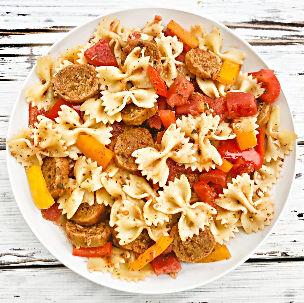 Vegan Sausage and Peppers Pasta - A quick and easy plant-based skillet dinner filled with spicy Italian sausage, colorful bell peppers, and pasta tossed together in a light and earthy tomato sauce. Ready to serve in 30 minutes or less!