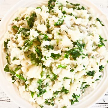 Spinach Mashed Potatoes - Fresh spinach sauteed with garlic with creamy mashed potatoes, butter, and seasonings. This hearty and healthy side dish is ready to serve in about 20 minutes.