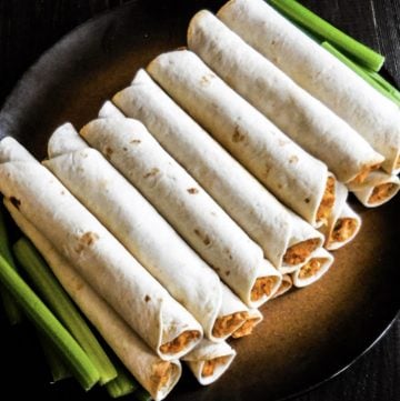Baked Buffalo Chickpea Taquitos  Perfect finger food for casual get-togethers or snacking on game day! Ready to serve 30 minutes or less, these baked taquitos are super easy to make and always a hit! 