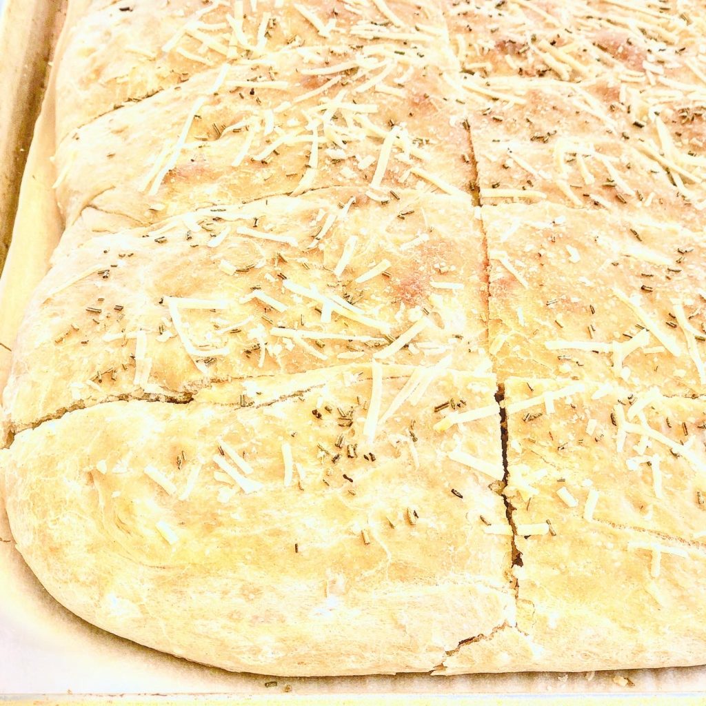 Rosemary Parmesan Focaccia Bread - Simple and super easy to make, this versatile flatbread pairs perfectly with all kinds of pasta dishes, soups, and salads. It's also delicious as a sandwich bread!