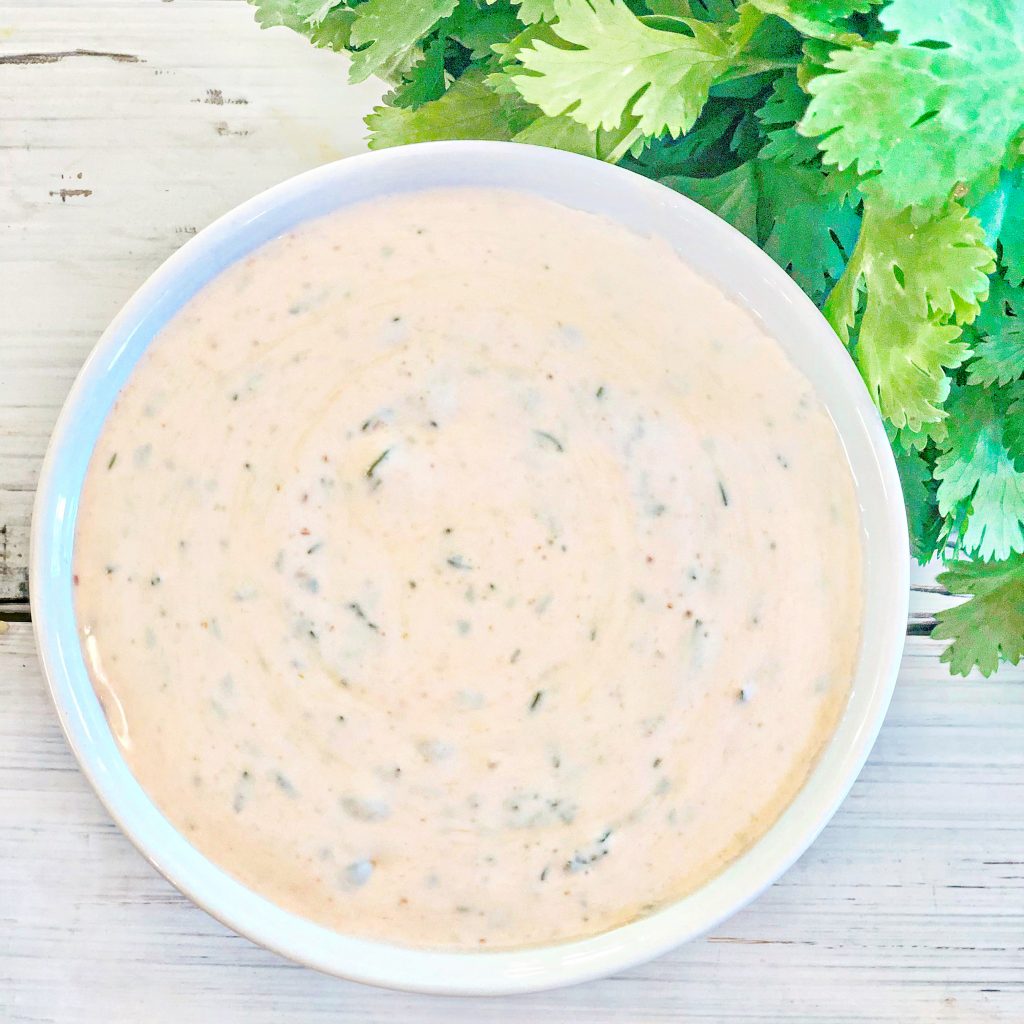 This easy to make and spicy cilantro lime sauce gets its kick from the addition of sriracha. Add a little or add a lot. You control the heat!     Only five simple ingredients and about 5 minutes are all you need.  This creamy and delicious dressing is perfect for drizzling over tacos, enchiladas, salads, burrito bowls, and even makes a great dip for chips, too.