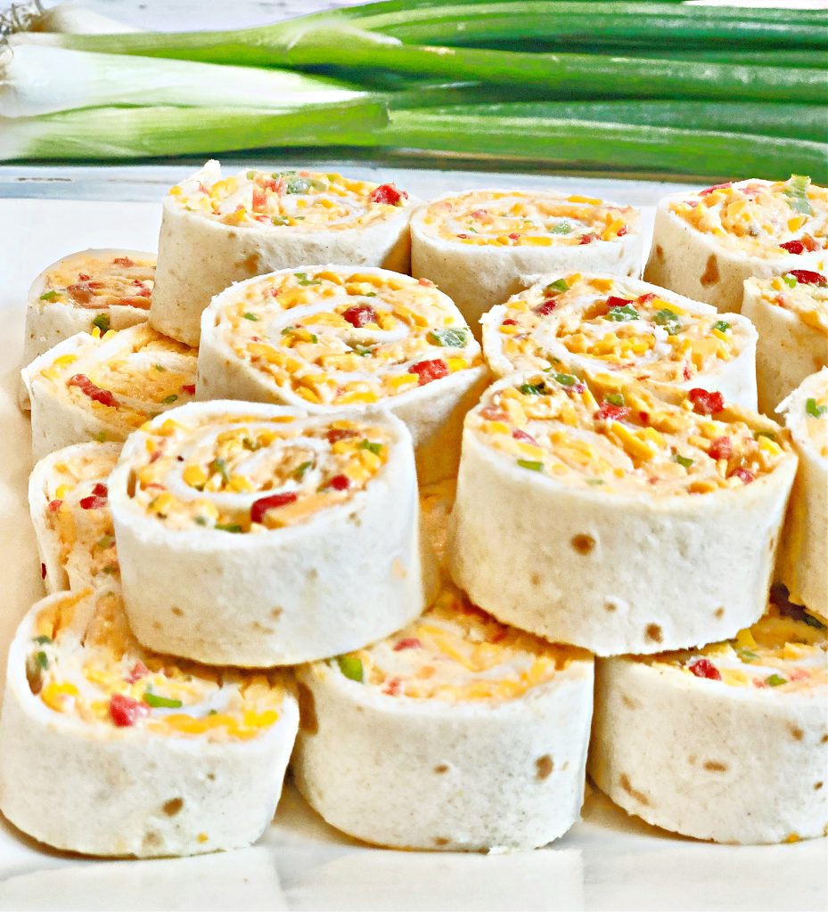 Spicy Pimento Cheese Pinwheels ~ A creamy mixture of dairy-free cheeses, mayonnaise, scallions, jalapeño pepper, pimentos, and spices are rolled into a flour tortilla and sliced into pinwheels. These crowd-pleasing appetizers can also be made ahead of time and refrigerated until ready to serve.