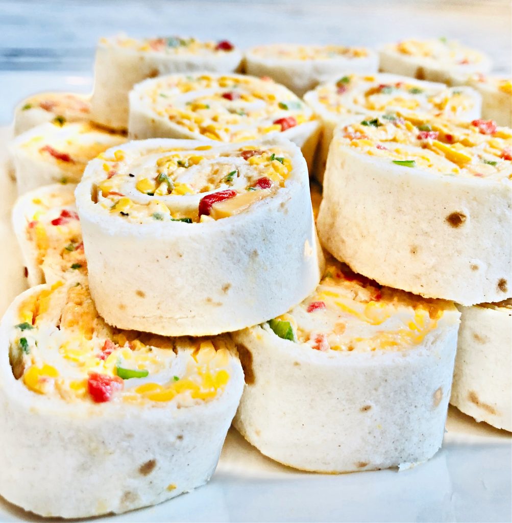 Spicy Pimento Cheese Pinwheels ~ A creamy mixture of dairy-free cheeses, mayonnaise, scallions, jalapeño pepper, pimentos, and spices are rolled into a flour tortilla and sliced into pinwheels. These crowd-pleasing appetizers can also be made ahead of time and refrigerated until ready to serve.
