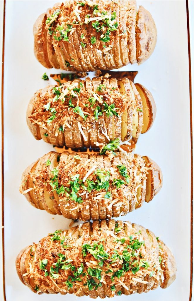 Hasselback Potatoes ~ Simple, savory, and perfect for holiday entertaining. These easy to make accordion-style baked potatoes are lightly crispy on the edges, creamy and buttery in the center, and topped with a mixture of dairy-free Parmesan and bread crumbs.