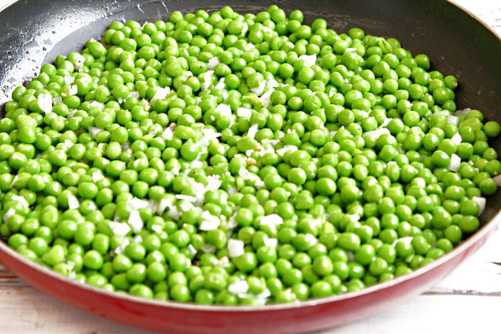 Green Peas ~ Boost the flavor of a bag of frozen peas with sauteed onions, garlic, and simple seasonings. An easy and classic side dish that works with a variety of cuisines.