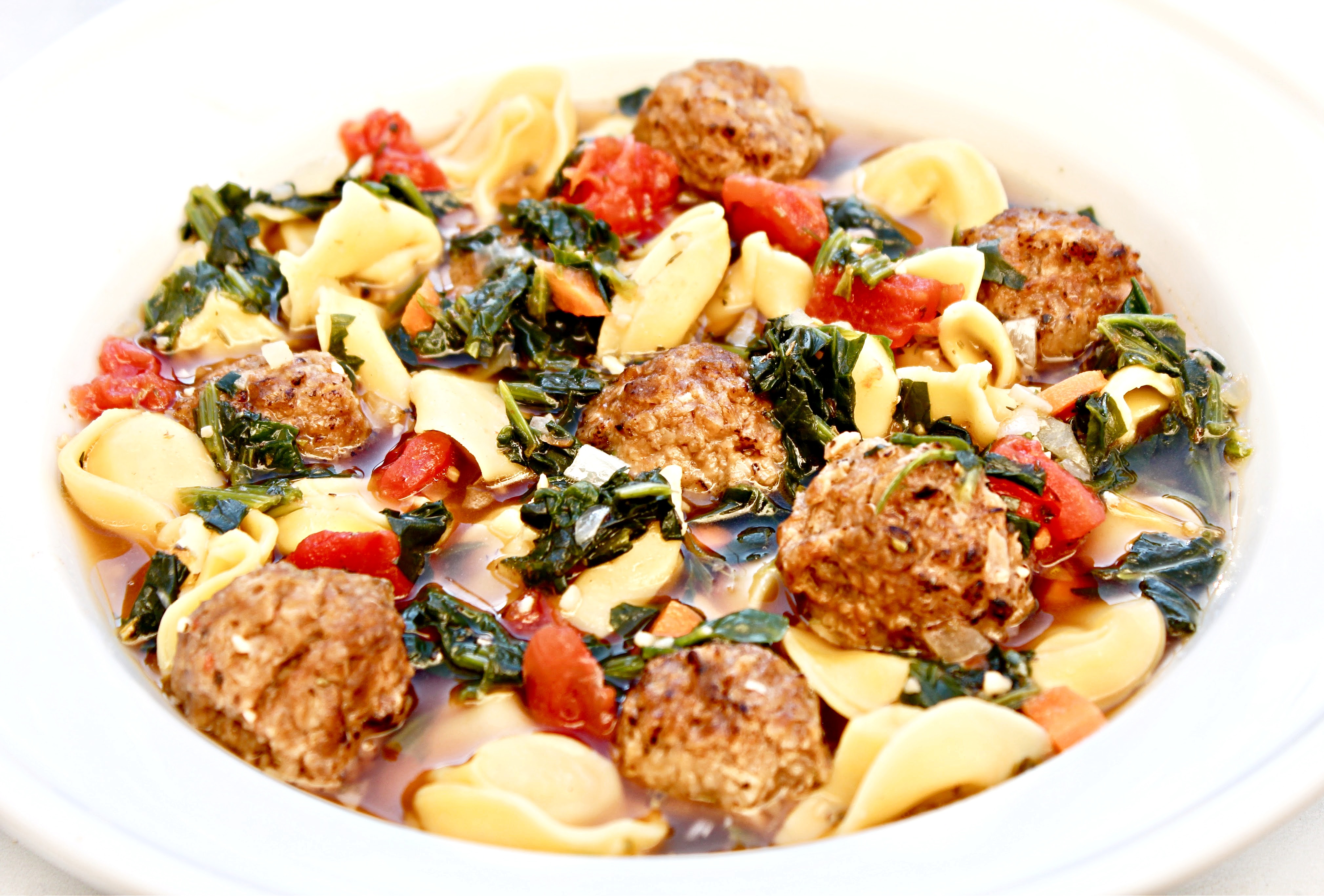 Meatball Tortellini Soup ~ Veggie meatballs and dairy-free cheese-filled tortellini served in a savory and meatless beef-style broth with carrots, onion, garlic, spinach, tomatoes, and seasonings. This is a simple yet robust and flavorful soup that is quick and easy to make in 30 minutes or less!