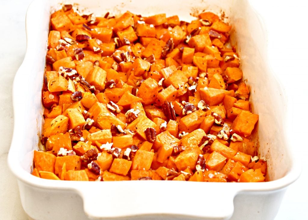 Roasted Sweet Potatoes ~ Bite-site chunks of sweet potatoes roasted with olive oil and maple syrup are lightly crisp on the outside and soft on the inside. Sea salt, ground black pepper, and toasted pecans add savory balance to this naturally sweet fall seasonal favorite. Ready to serve in under an hour and make an easy and flavorful side dish for Thanksgiving or Christmas dinner.