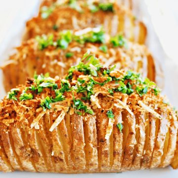 Hasselback Potatoes ~ Simple, savory, and perfect for holiday entertaining. These easy to make accordion-style baked potatoes are lightly crispy on the edges, creamy and buttery in the center, and topped with a mixture of dairy-free Parmesan and bread crumbs.