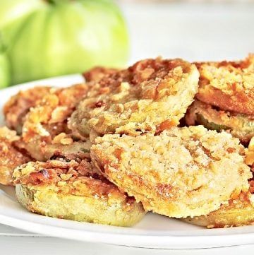 Fried Green Tomatoes ~ Batter-coated and fried until soft inside and perfectly crispy outside. Cajun seasoning adds a Louisiana-style kick!