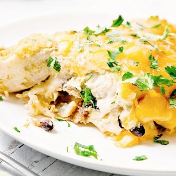 Potato and Black Bean Green Chile Enchiladas are easy to make and budget-friendly. Made with simple ingredients and pantry staples in under an hour.