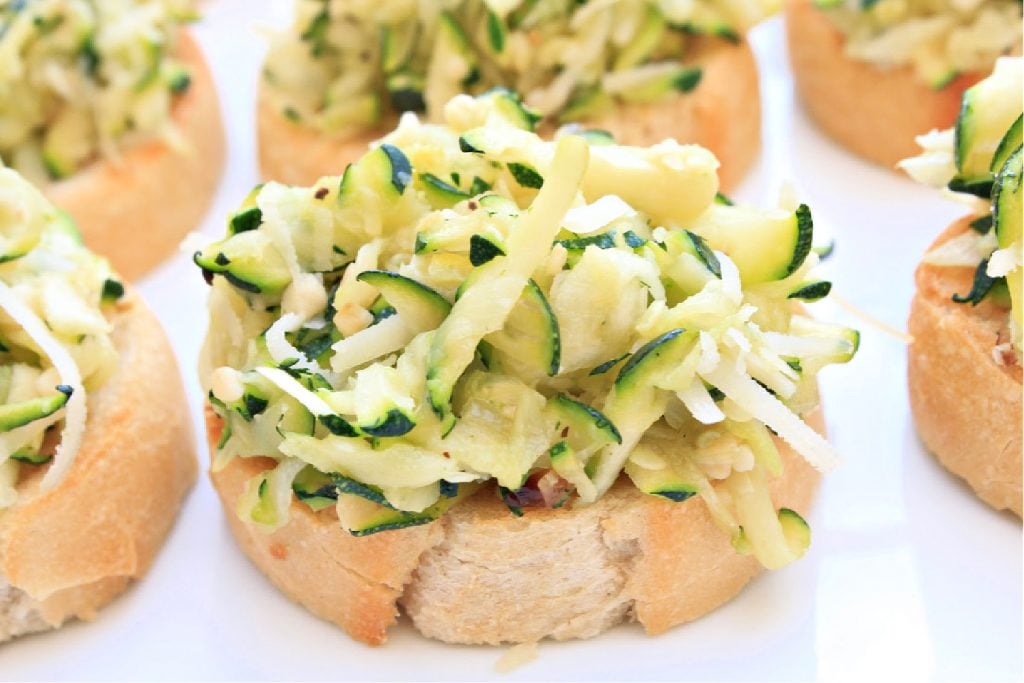 Zucchini Crostini ~ Toasted baguette with an easy bruschetta of grated zucchini, vegan parmesan, garlic and onion, and simple seasonings. Perfect for the warmer months as an appetizer or light meal served outdoors.