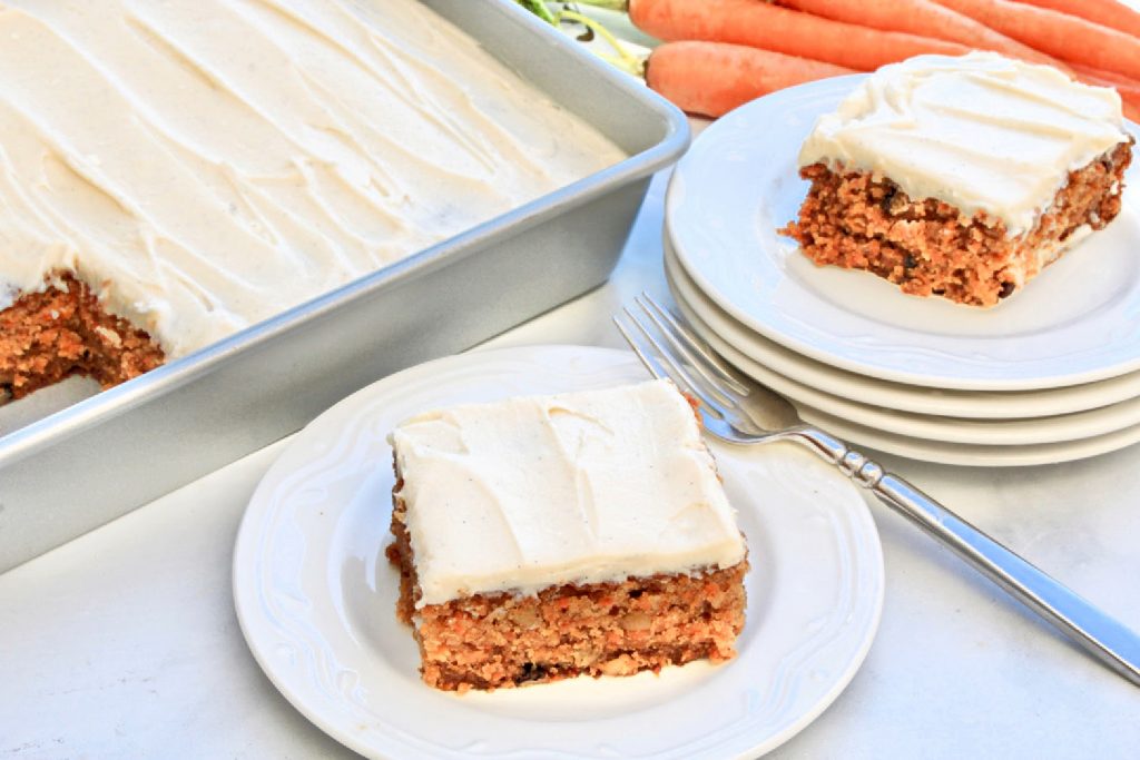 Vegan Carrot Cake ~ This light and tender cake is perfectly sweet, loaded with freshly grated carrots, studded with walnuts, and infused with warm spices of cinnamon and nutmeg in every bite!