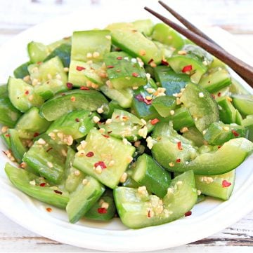 smashed cucumber salad in bowl with chopsticks