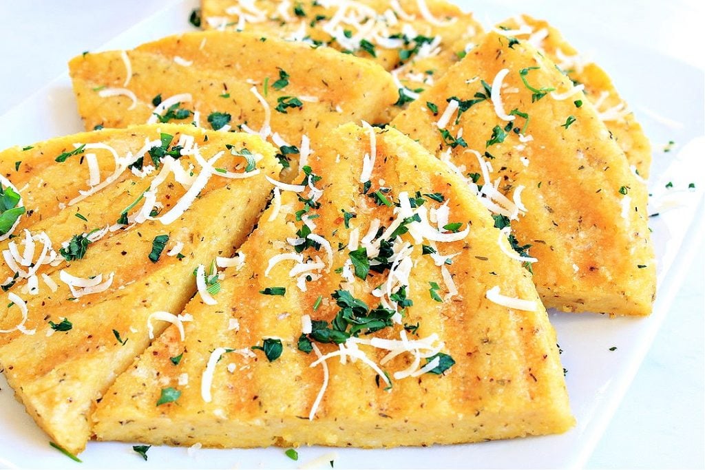 Polenta grilled and topped with parmesan and parsley.