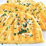 Polenta grilled and topped with parmesan and parsley.