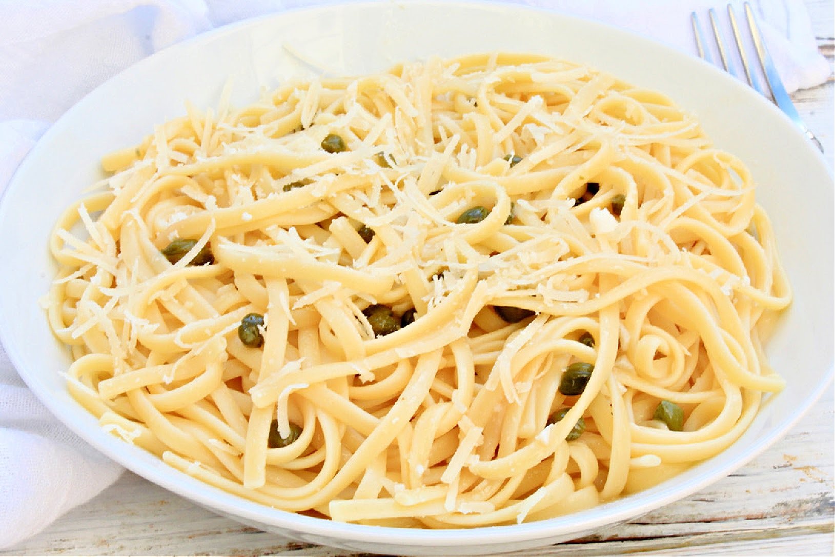 Pasta Piccata ~ Linguine tossed in a lemon, butter, and capers sauce is simple, satisfying, and on the table in 20 minutes or less!