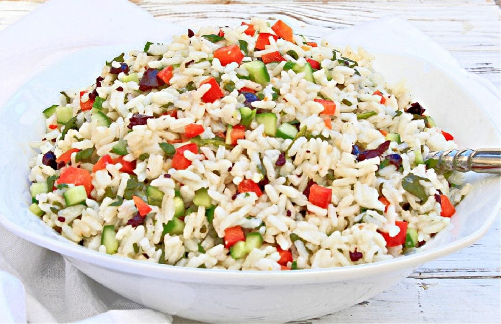 Italian Rice Salad ~ A light and easy grain salad with spinach, peppers, cucumbers, and olives tossed in Italian-style dressing.