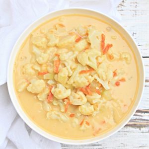 Cheesy Cauliflower Soup ~ A creamy, flavorful, dairy-free soup loaded with cauliflower and vegan cheddar. Ready to serve in under 30 minutes!