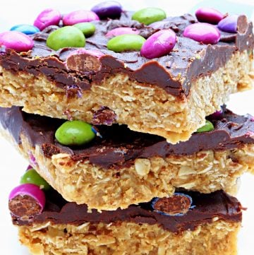 Vegan Monster Cookie Bars ~ Peanut butter and oatmeal cookie dough smothered in chocolate and studded with colorful candies is an easy, no-bake dessert treat that is frightfully delicious!