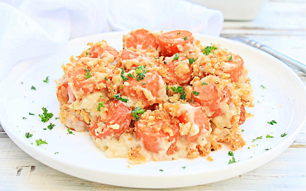 Carrots Au Gratin ~ Naturally sweet carrots baked in a creamy cheese sauce and sprinkled with a buttery cracker crumb topping. This cheesy carrot casserole makes a delicious addition to your holiday menu!