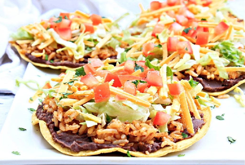 Rice and Bean Tostadas ~ Layers of Tex-Mex toppings on crisp tortilla shells. Kids and adults love this easy and simple handheld dinner!