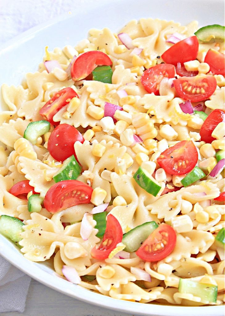Summer Pasta Salad ~ Fresh from the garden vegetables tossed with farfalle pasta and tangy homemade lemon dressing. Perfect for all your summertime potlucks and cookouts!