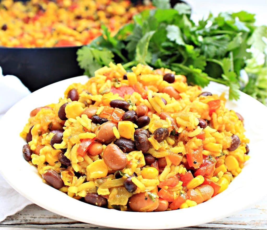 Serve this savory dish made with black and pinto beans, seasoned rice, and vegetables as a hearty side dish or main course.