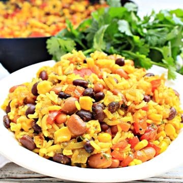 Serve this savory dish made with black and pinto beans, seasoned rice, and vegetables as a hearty side dish or main course.