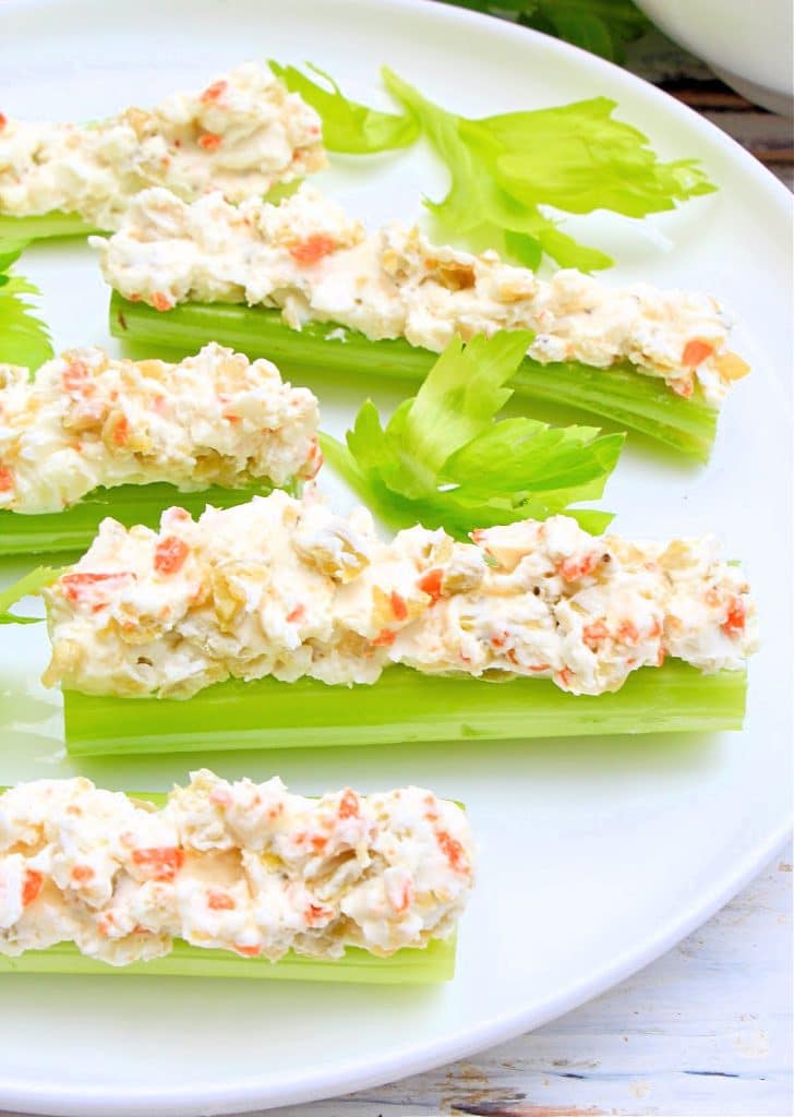 Crisp celery stuffed with a simple and savory mixture of cream cheese and olives. Serve as a low-carb snack or holiday appetizer!