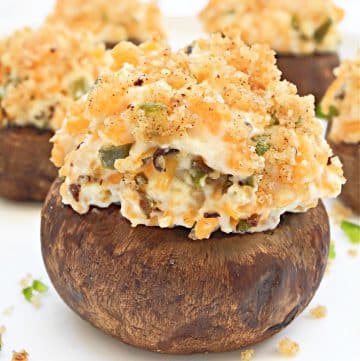 Jalapeno Popper Stuffed Mushrooms ~ Baked mushrooms stuffed with creamy dairy-free cheeses, jalapeno pepper, and buttery breadcrumb topping. Serve as an easy holiday appetizer or game day snack!
