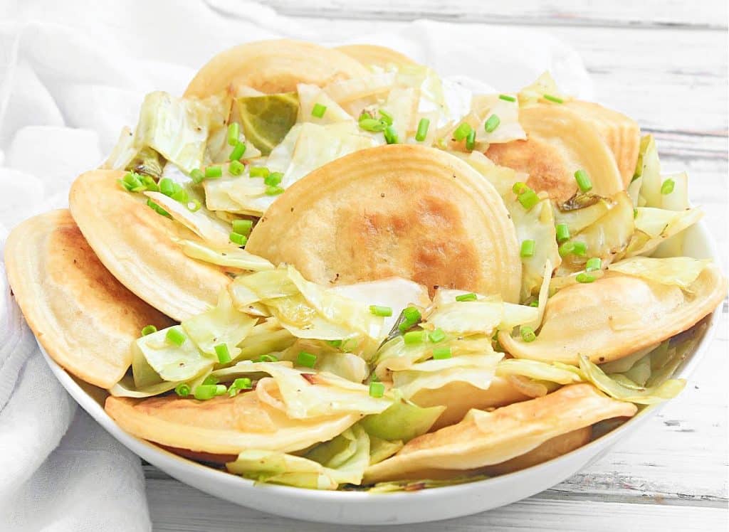 Pierogies and Cabbage ~ Pan-fried pierogies with caramelized cabbage and onions. This one-skillet meal is ready to serve in just 20 minutes!