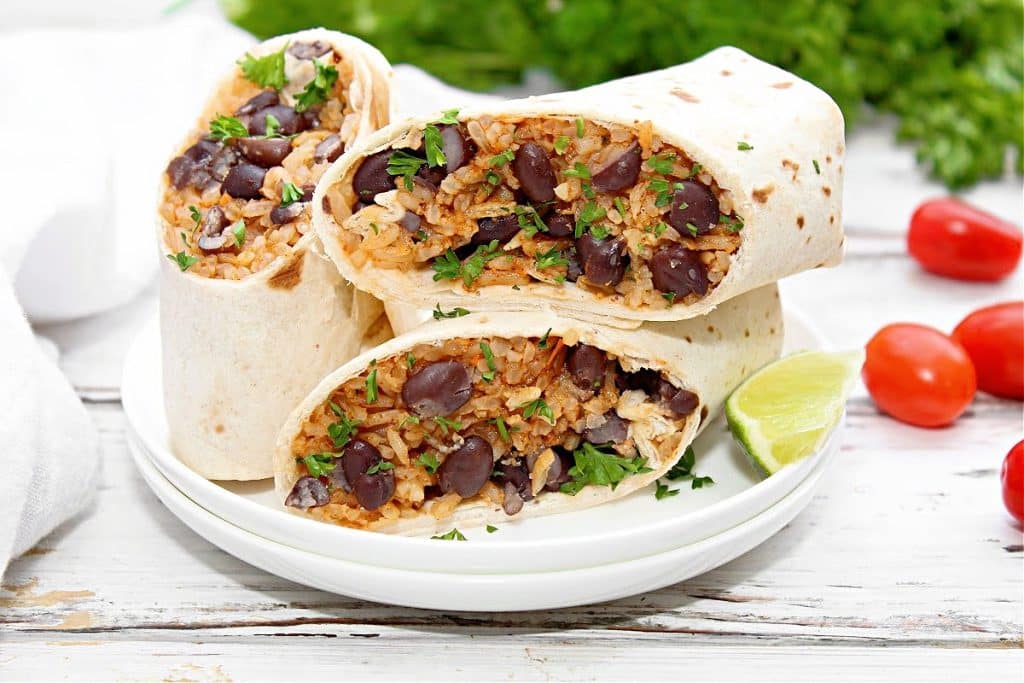 Rice and Bean Burritos ~ Taco-seasoned rice and protein-packed black beans wrapped in flour tortillas for a quick and easy lunch or dinner. These freezer-friendly wraps are also perfect for meal prep!