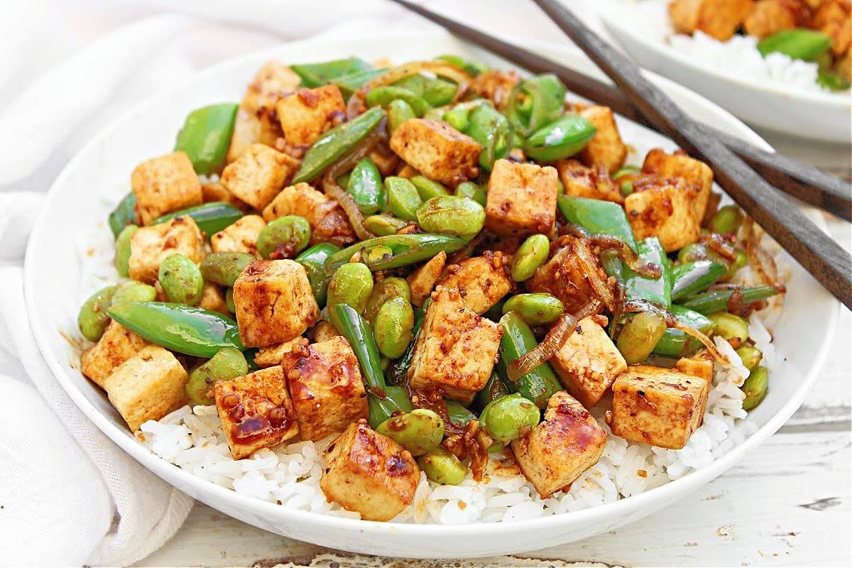 Tofu Stir Fry Rice Bowls ~ Easy plant-based dinner with pan-seared tofu, crisp snap peas, edamame, and a homemade vegan stir-fry sauce.