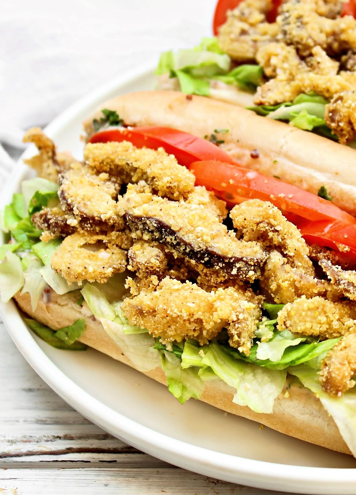 Mushroom Po' Boys ~ Louisiana-style sandwiches stuffed with crispy fried mushrooms, fresh veggies, and zesty homemade remoulade sauce.