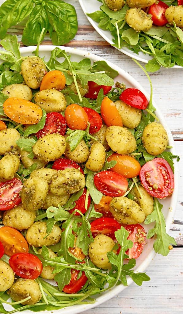Pesto Gnocchi Salad ~ Roasted gnocchi coated in Homemade Basil Pesto and served over a bed of peppery arugula with bright cherry tomatoes.