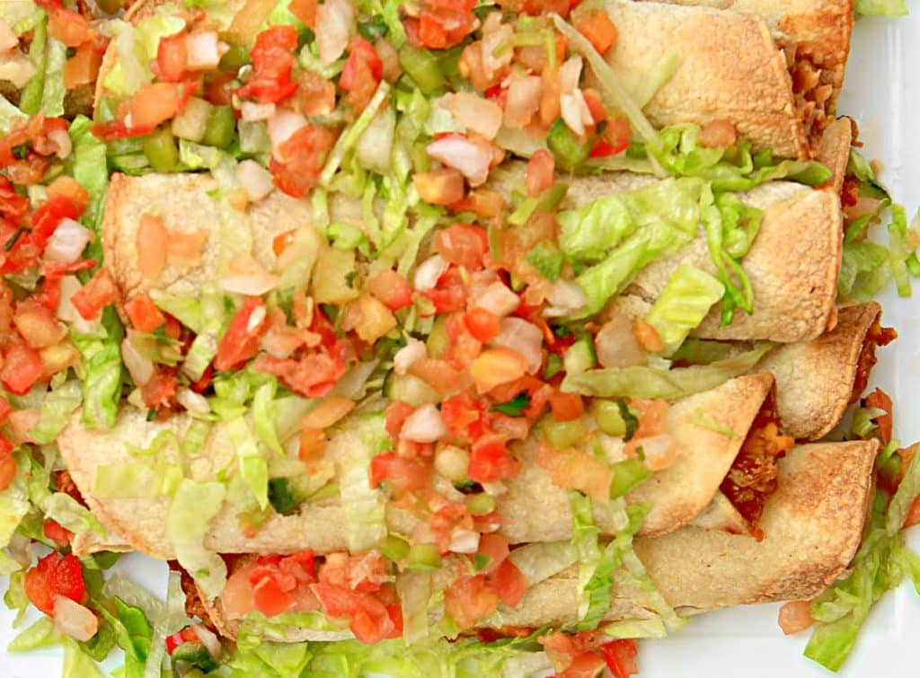 Bean and Cheese Taquitos ~ A classic Tex-Mex favorite for a Super Bowl party or easy weeknight dinner with your favorite toppings!